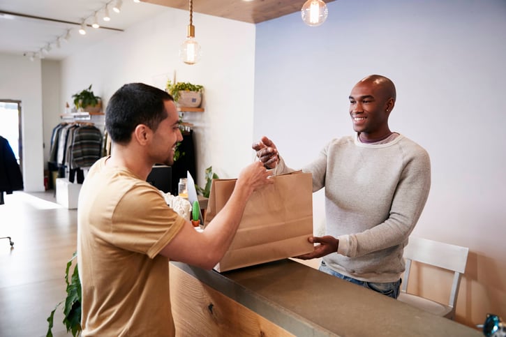 man-serving-customer-at-the-counter-in-a-clothing-2026-01-05-06-31-16-utc (1)
